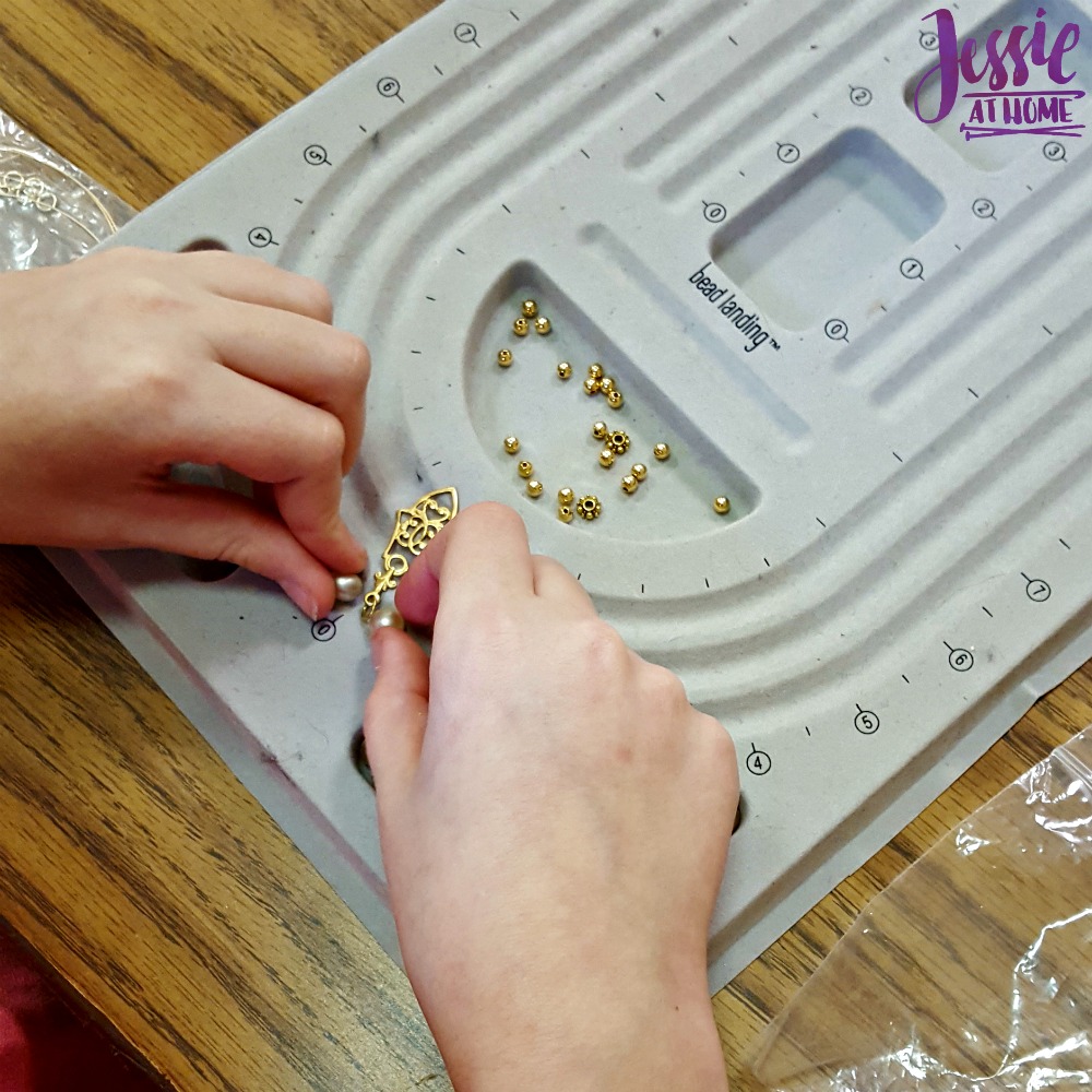 Kyla making her necklace