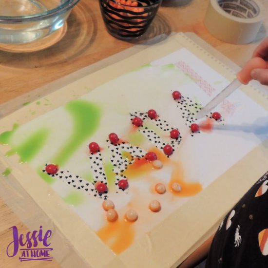 Painting with Skittles craft tutorial by Jessie At Home - Vada in process